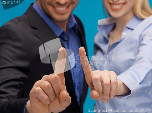 Image of man and woman hands pointing at something
