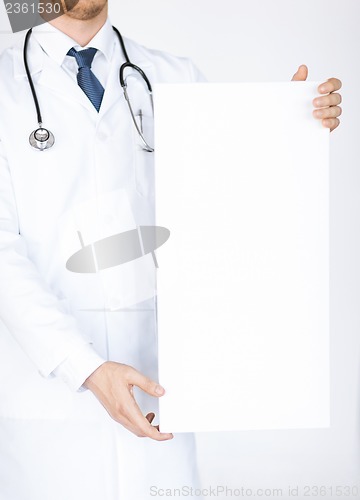 Image of doctor holding blank white banner