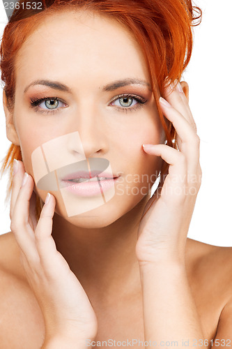 Image of woman touching her face