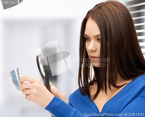 Image of woman with magnifying glass and euro cash money