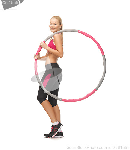 Image of young sporty woman with hula hoop