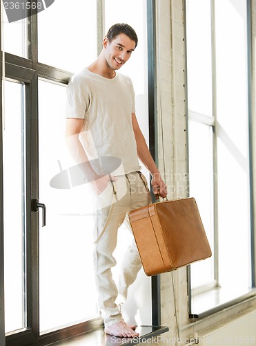 Image of handsome man with retro suitcase