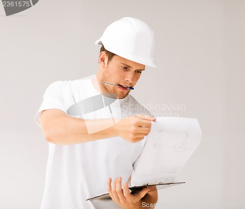 Image of male architect looking at blueprint