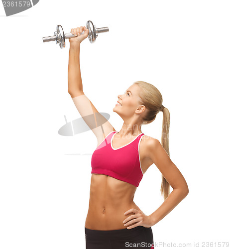 Image of woman lifting steel dumbbell
