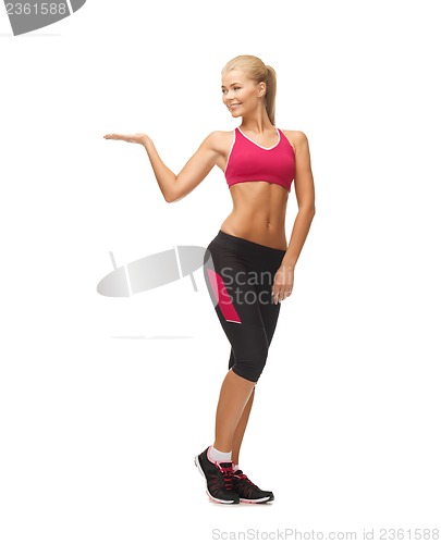 Image of woman in sportswear with empty hand