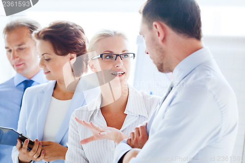 Image of man and woman having discussion in office