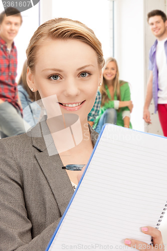 Image of teacher with big notepad at school