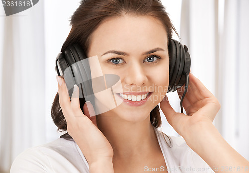 Image of happy teenage girl in big headphones