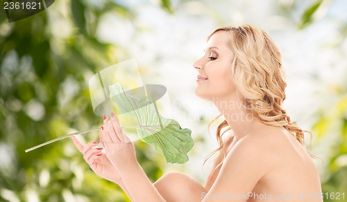 Image of woman with green leaf