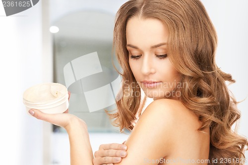 Image of beautiful woman with moisturizing creme