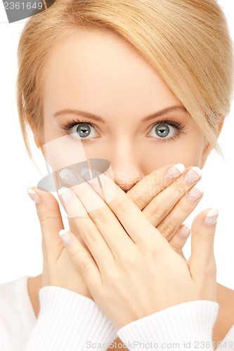 Image of amazed woman with hand over mouth