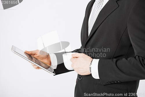 Image of man with tablet pc and cup of coffee