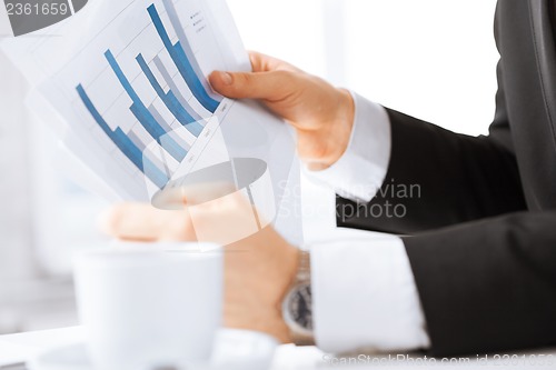 Image of businessman on meeting discussing graphics
