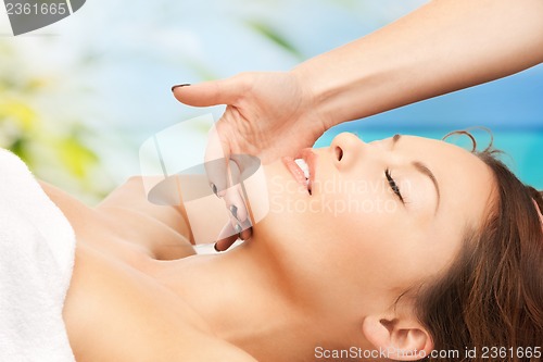Image of woman on resort getting face spa treatment