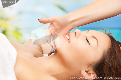 Image of woman on resort getting face spa treatment