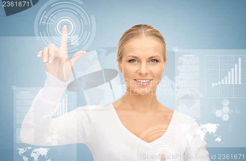 Image of businesswoman touching virtual screen