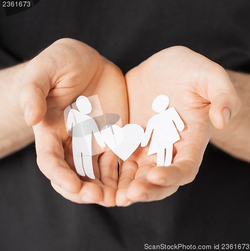 Image of man hands with paper men