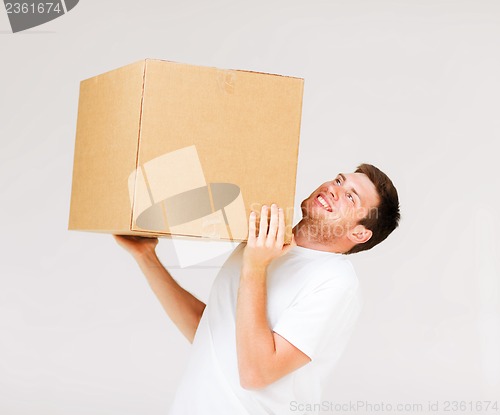 Image of man carrying carton heavy box