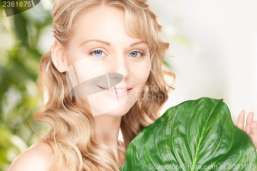 Image of woman with green leaf