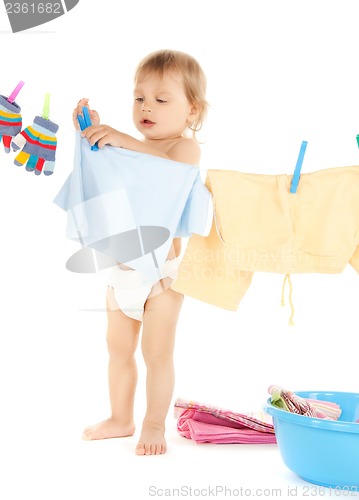 Image of baby doing laundry