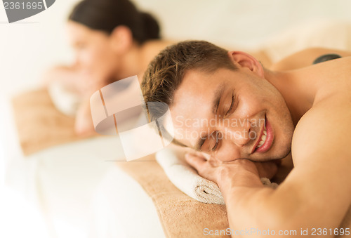 Image of couple in spa with hot stones