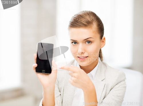 Image of businesswoman with smartphone in office