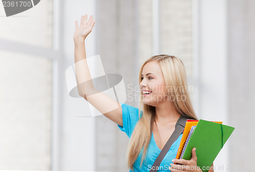 Image of student with folders