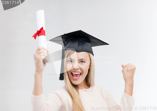 Image of student in graduation cap with certificate