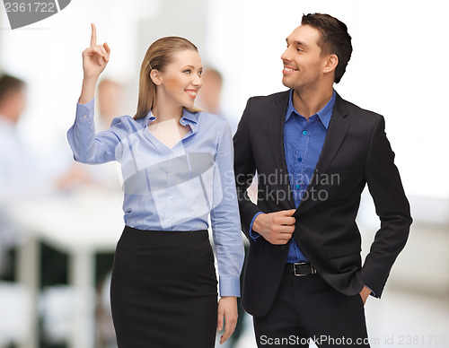 Image of man and woman pointing finger