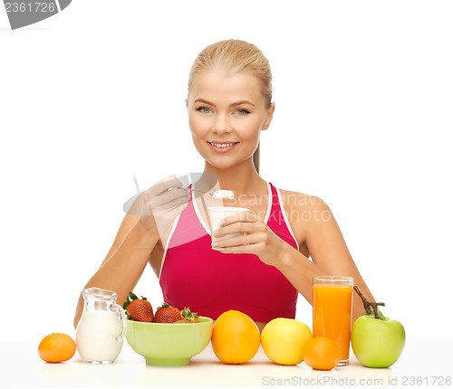 Image of young woman eating healthy breakfast