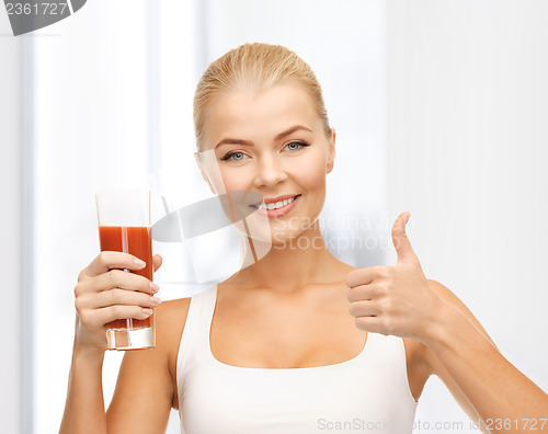 Image of woman holding glass of tomato juice