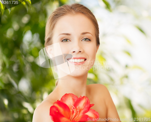Image of beautiful woman with red lily flower
