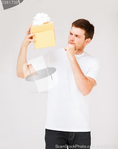 Image of man in white t-shirt with gift box