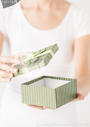 Image of woman hands with gift box