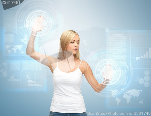 Image of businesswoman touching virtual screen