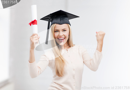 Image of student in graduation cap with certificate