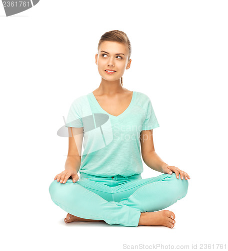 Image of girl sitting in lotus position and meditating