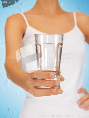 Image of woman hands holding glass of water