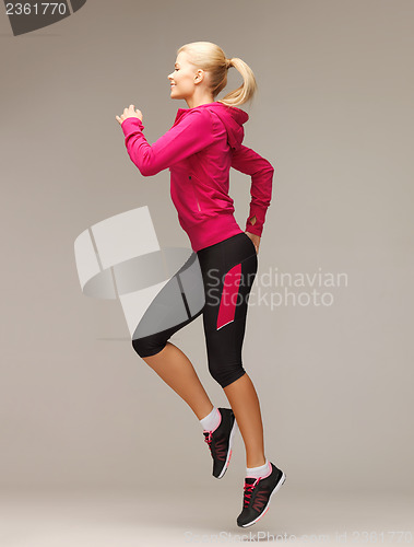 Image of sporty woman running or jumping