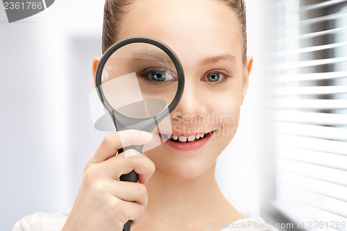 Image of teenage girl with magnifying glass