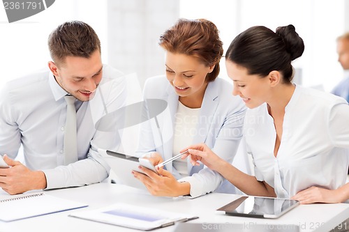 Image of business team working with tablet pcs in office