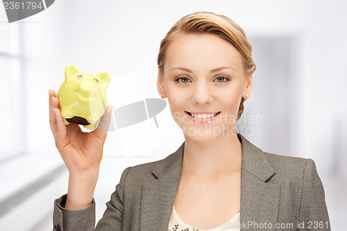 Image of lovely woman with piggy bank