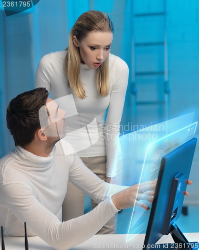 Image of man and woman working with virtual screen