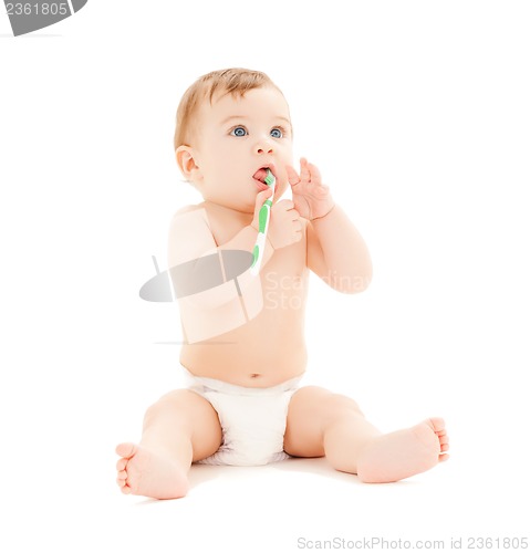 Image of curious baby brushing teeth