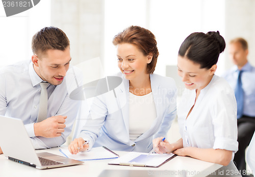 Image of business team discussing something in office