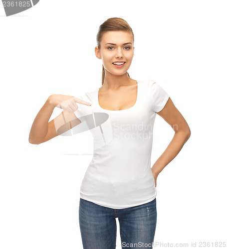Image of smiling woman pointing at blank white t-shirt