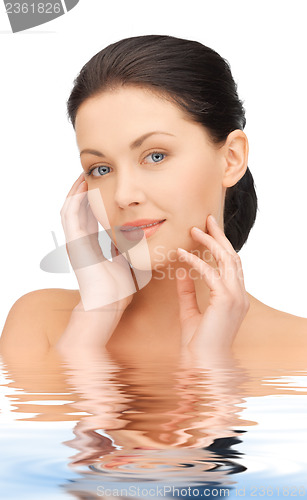 Image of woman touching her face