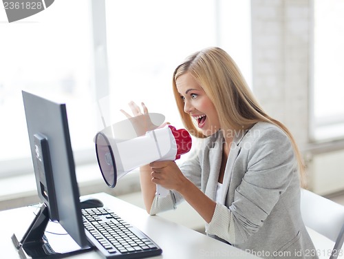 Image of crazy businesswoman shouting in megaphone