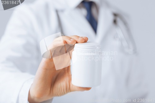 Image of doctor hands holding white pack