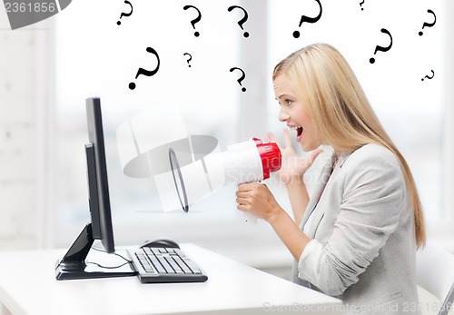 Image of strict businesswoman shouting in megaphone